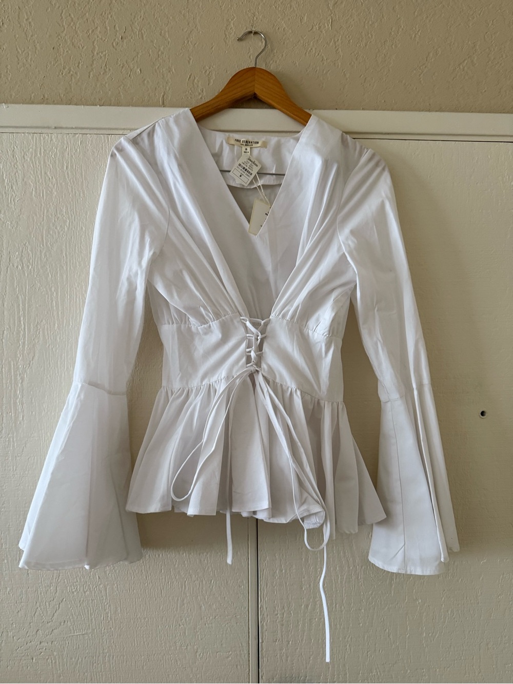 FREE GENERATION: White Lace Up Peplum Blouse with Flared Sleeves